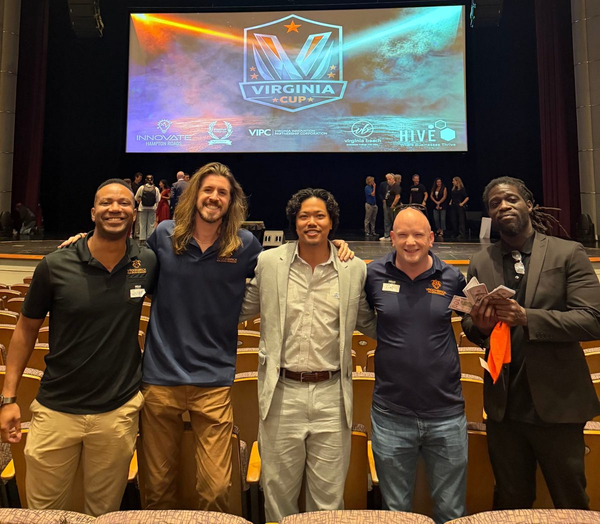 Five members of the VroomBrick team in VroomBrick shirts at the Virginia Cup startup competition.